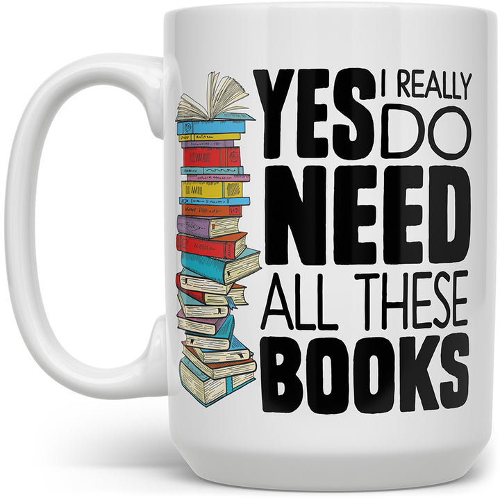 White mug that says Yes, I really do need all these books with a stack of books